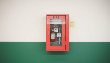 A fire fighting cabinet mounted on a wall