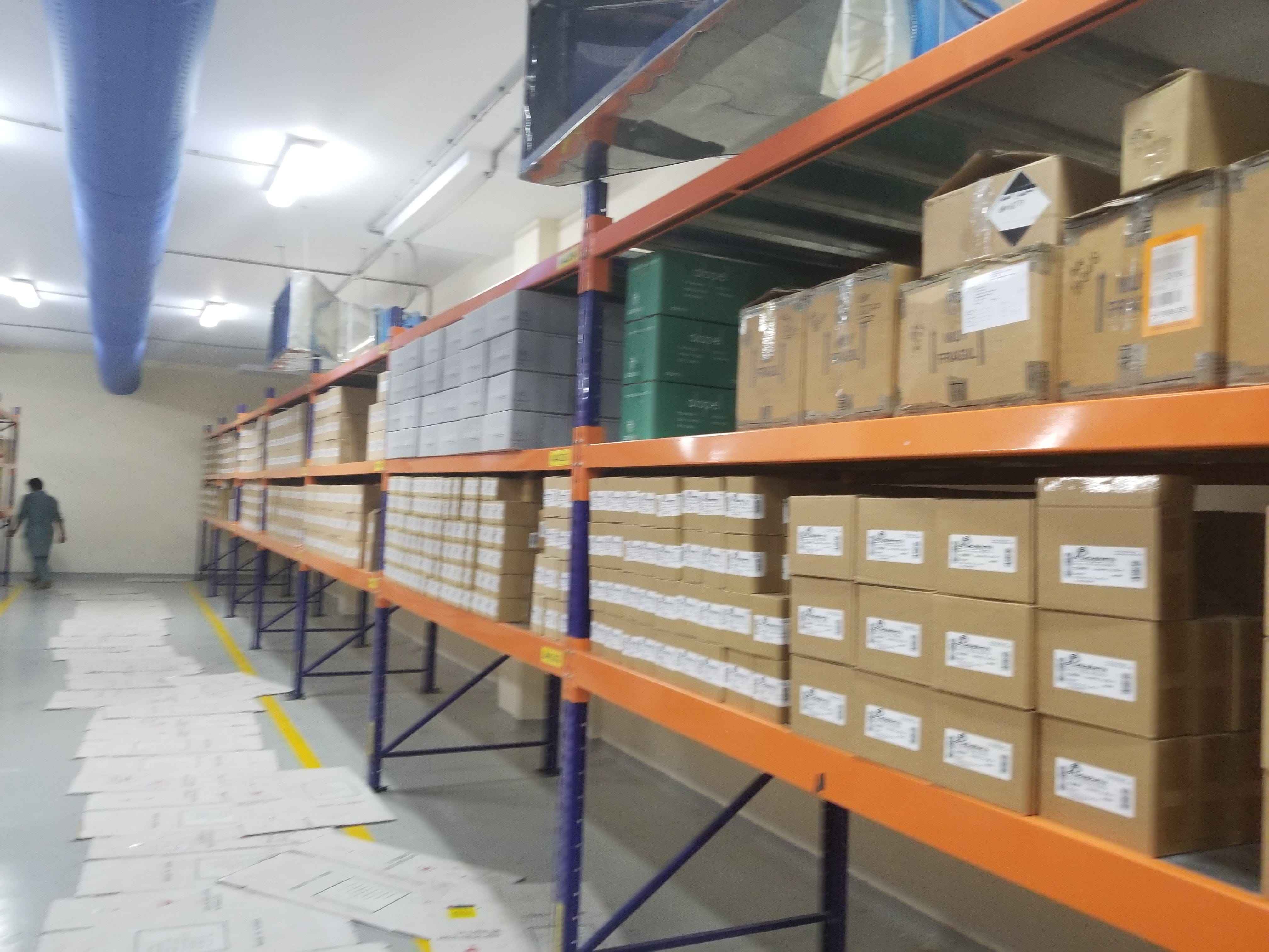 KSP SafeVault heavy duty racking industrial shelving with orange beams and blue supports storing boxes