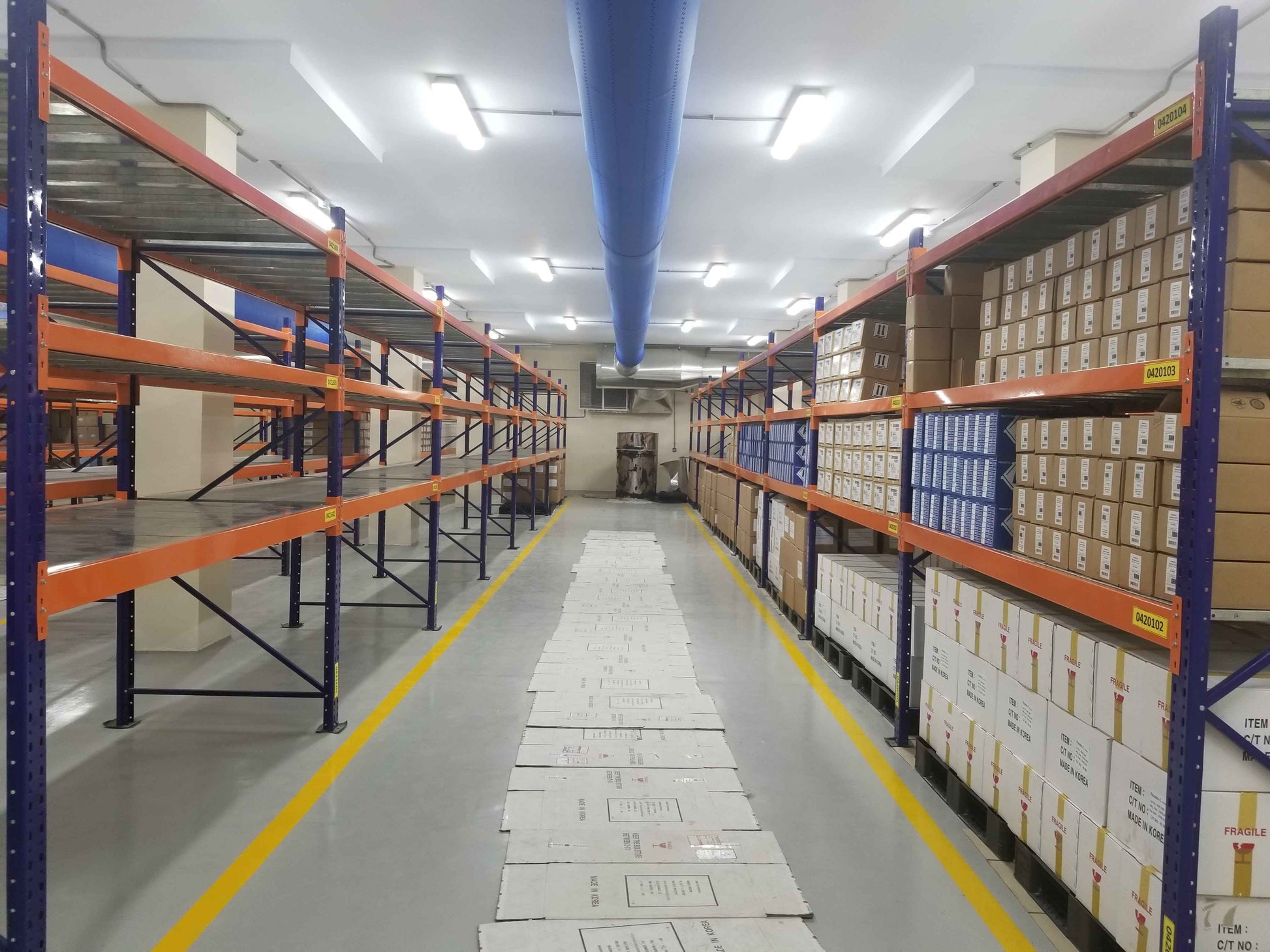 KSP Safe&Vault heavy duty racking industrial shelving system with orange and blue metal frames storing boxes