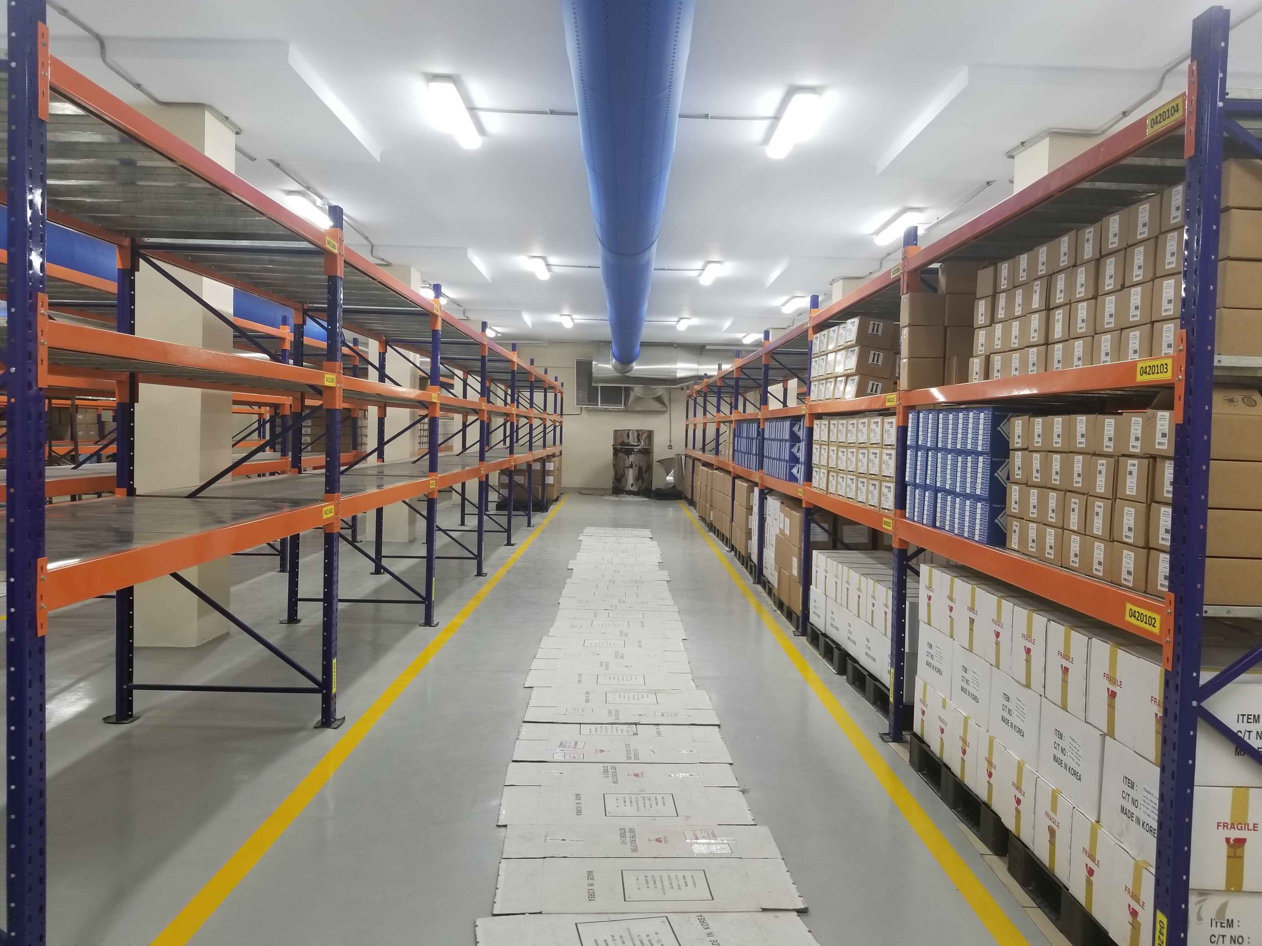 KSP Safe&Vault heavy duty racking industrial shelving system with orange and blue metal frames storing boxes