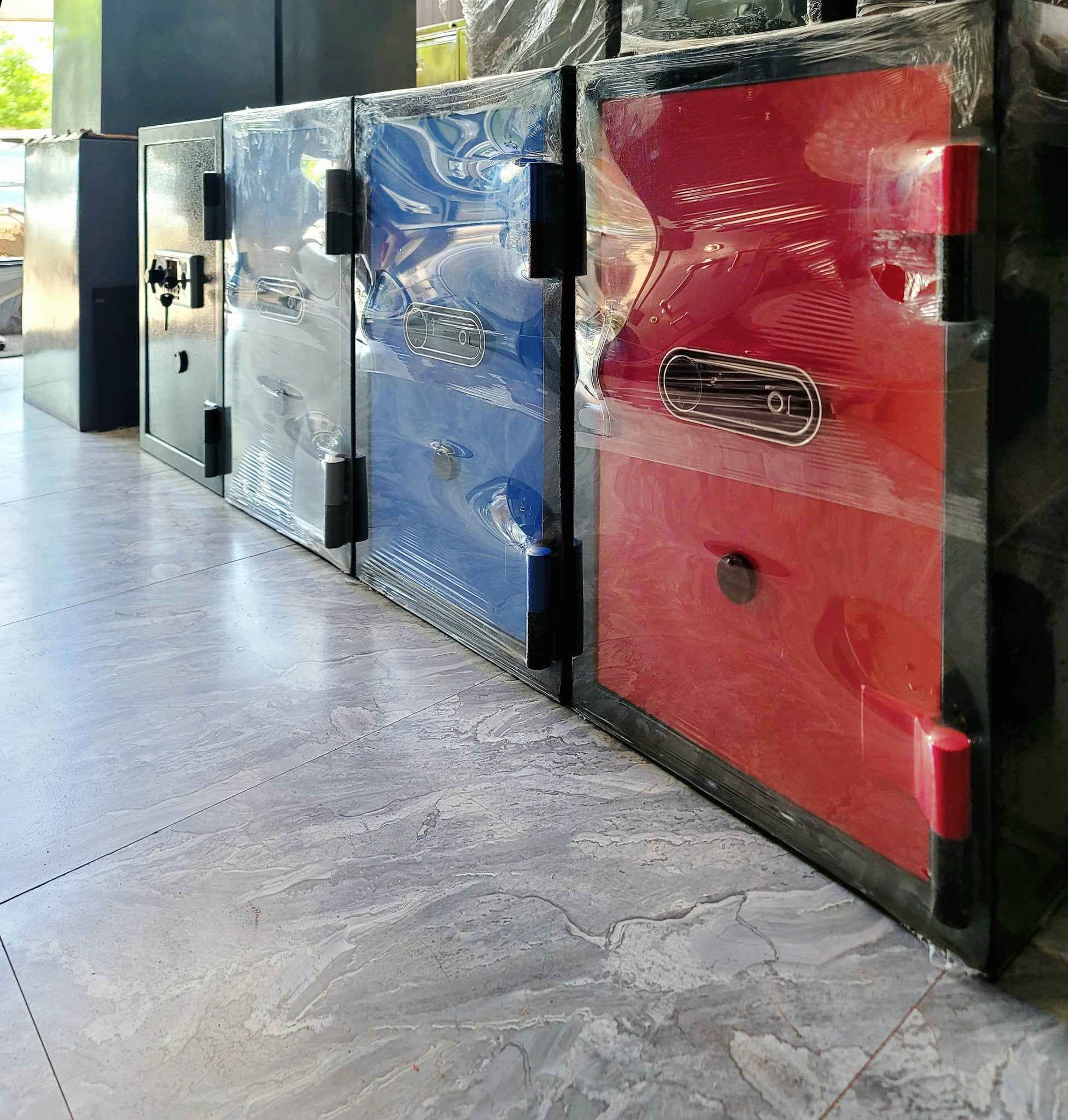 Bio-Metric Safe FRB-28 row of wrapped colored security safes red blue black on showroom floor