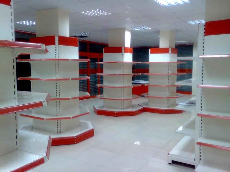 KSP supermarket shelving with multiple white and red wall shelves and ledges in store interior