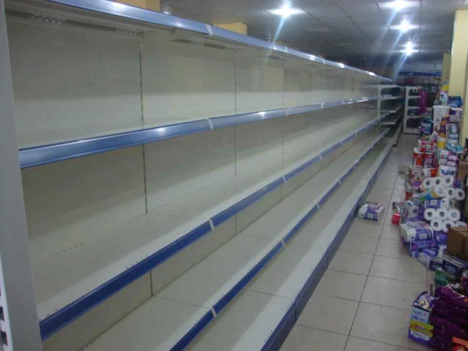 KSP empty supermarket shelving wall shelves and ledges in an aisle with tile flooring