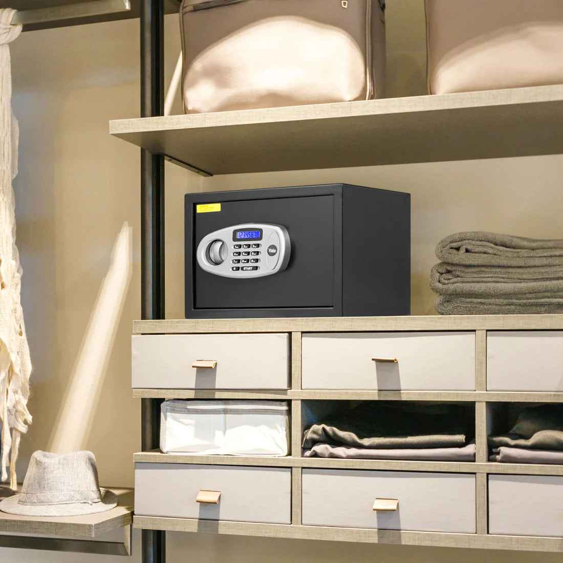 Yale Home Security Safe Lockers With Pincode Access stored on a shelf with towels and bags